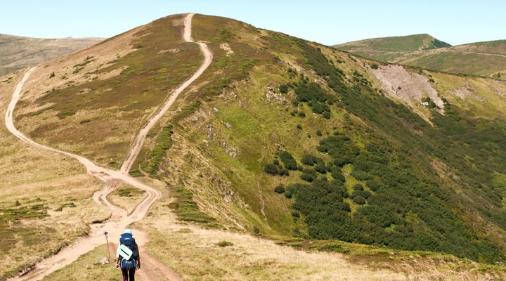 Hiker approaching a fork in a path