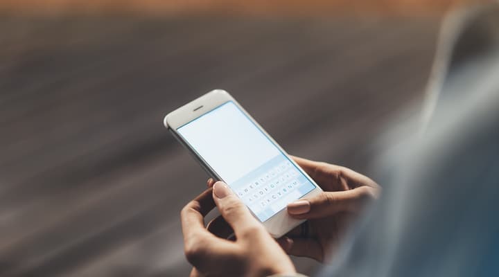 Close up of a woman holding a smartphone