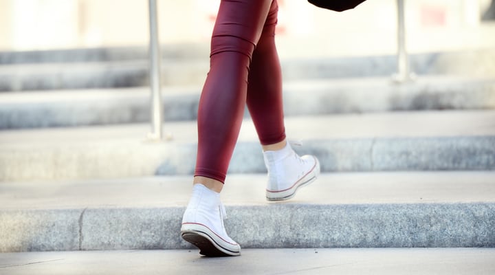 Close up of woman walking up stairs