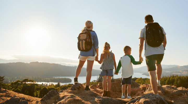 A family standing at the top of a hill in the Lake District, UK.