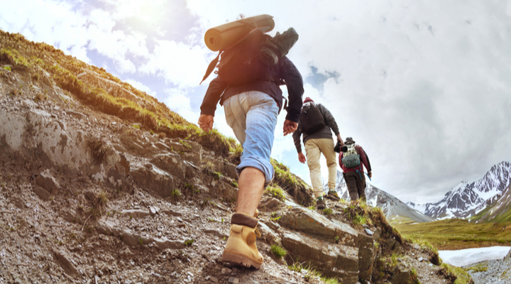 Hikers walking up a hill.