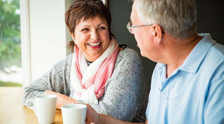 A couple talking over a coffee.