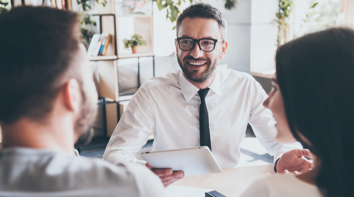 A couple in a meeting with a financial adviser.