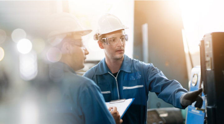 Two workers in a factory.