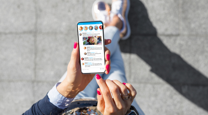 A woman using social media on her phone.