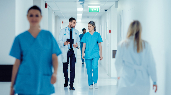 Doctors walking down a hospital corridor.