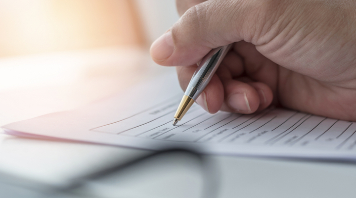 A person filling in paperwork.