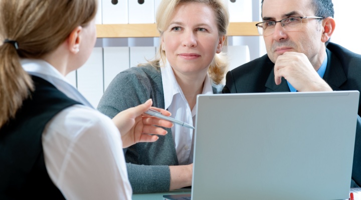 A couple talking to a financial planner.
