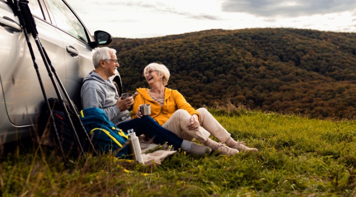 An older couple resting after a hike.