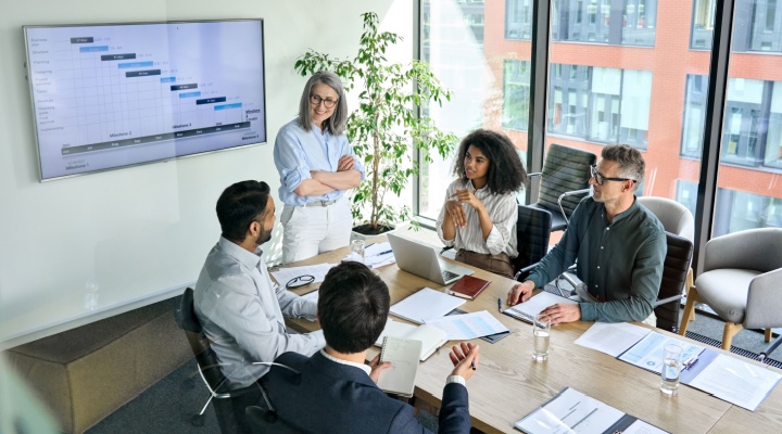 A woman presenting to her colleagues.