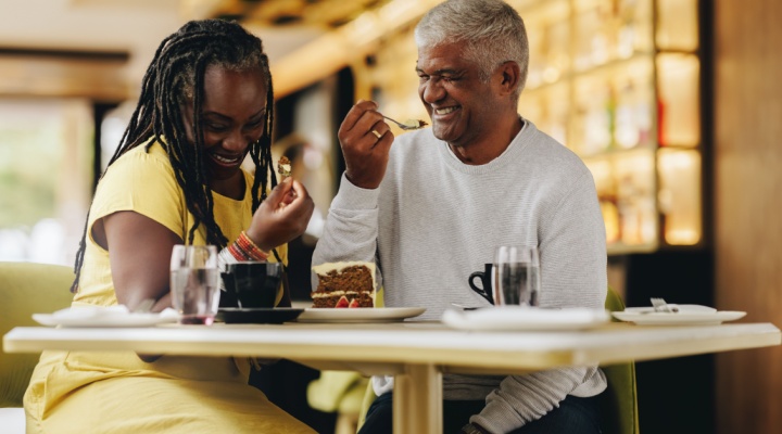 A couple laughing together at a café.