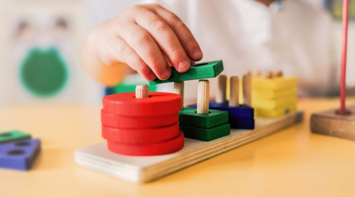 A child playing with wooden shapes.
