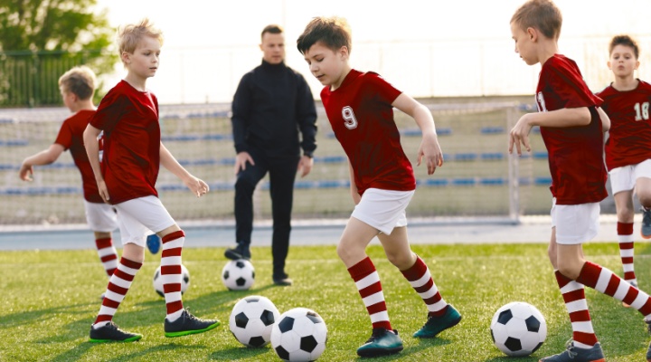A children’s football coach watching a training session.