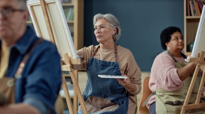 A group painting on easels in an art studio.