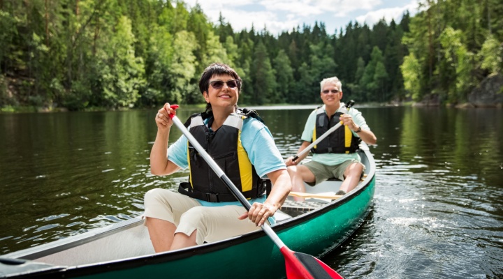 A couple on holiday taking a canoe ride.